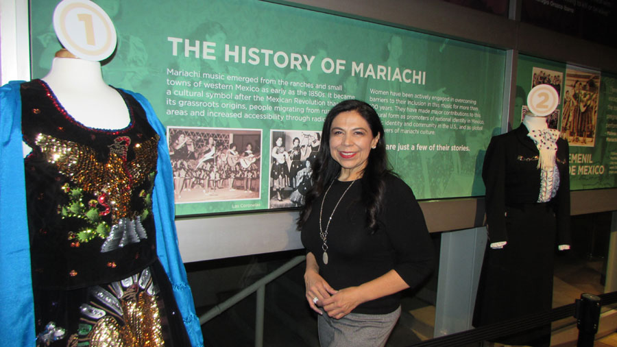 Dr. Leonor Xóchitl Pérez - in front of the exhibit she brought to Denver for the world premier of American Mariachi. Xóchitl Pérez is the Director and Founder of the Mariachi Women's Festival, Dr. Leonor Xóchitl Pérez began performing mariachi music in the 1970’s at Griffith Junior High School which is located in East Los Angeles, California.